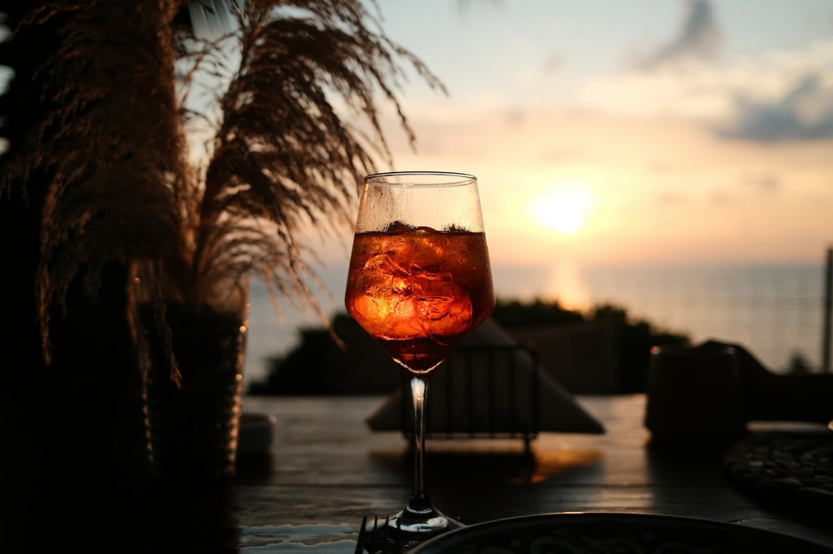 A cocktail glass on a terrace at sunset