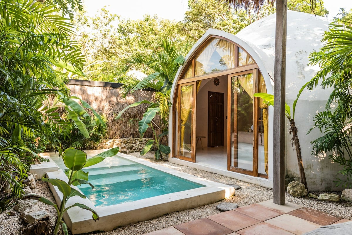 A small villa with a plunge pool in a tropical garden
