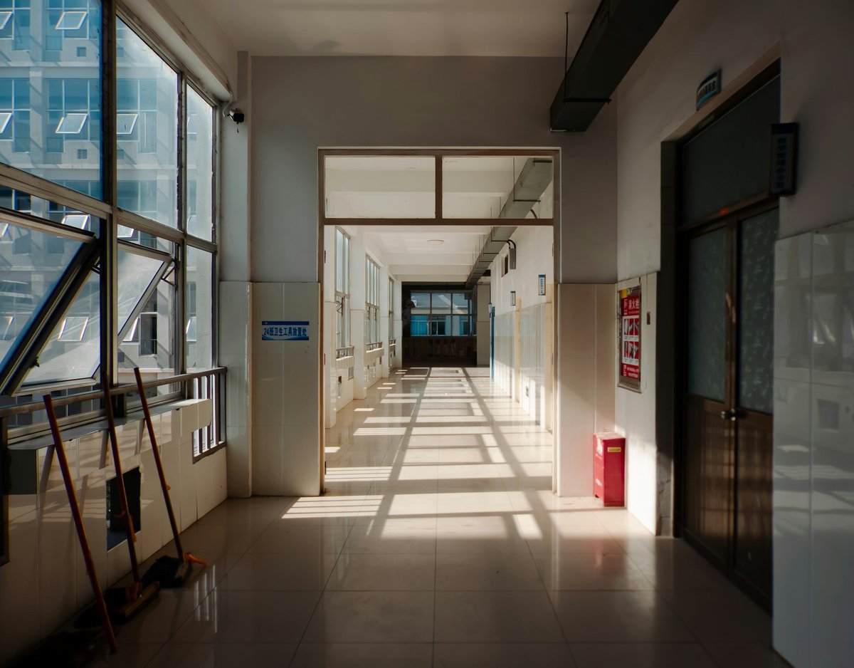 A sunlit, empty hospital corridor