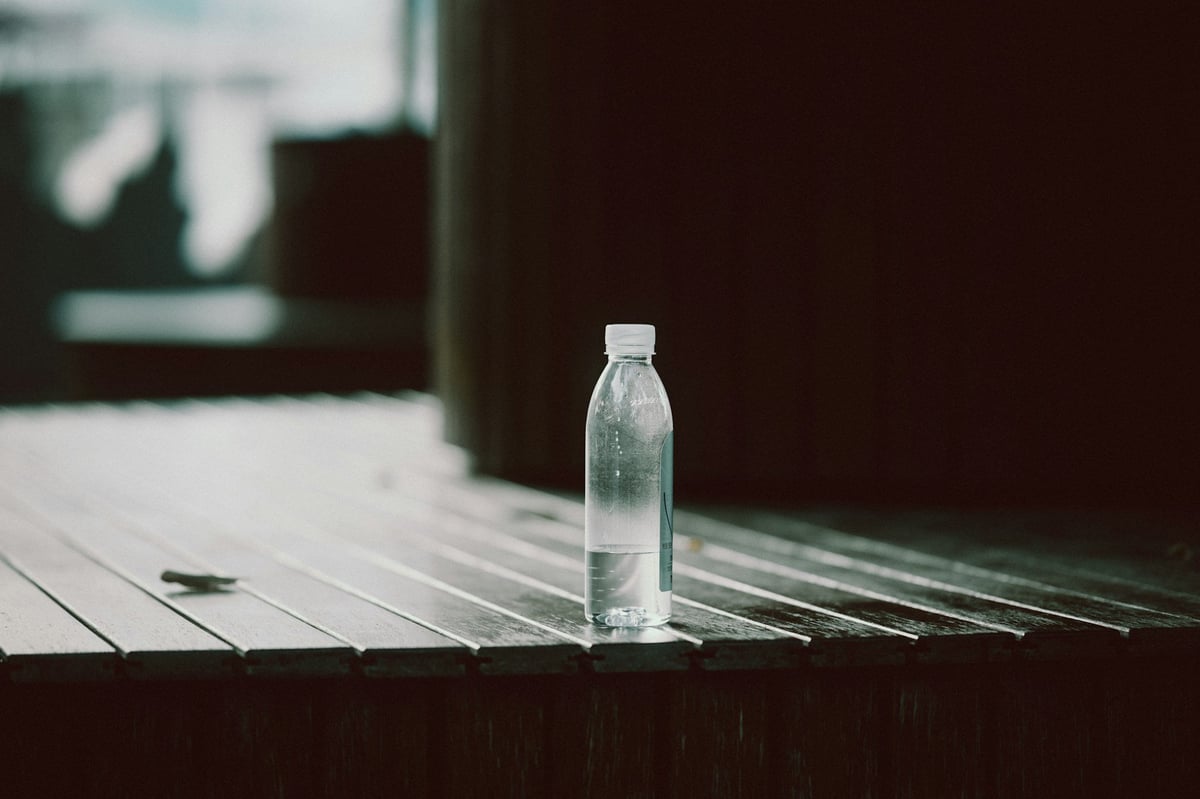 A bottle of water on a wooden deck