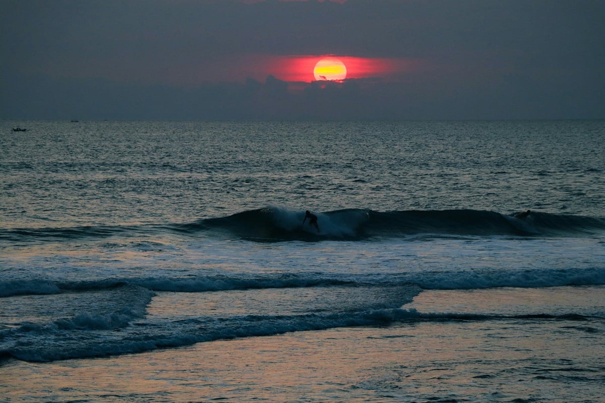 A wave breaking off Bali's west coast at sunset