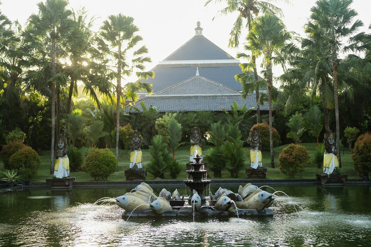 A garden pond and pavilion among palms in central Bali