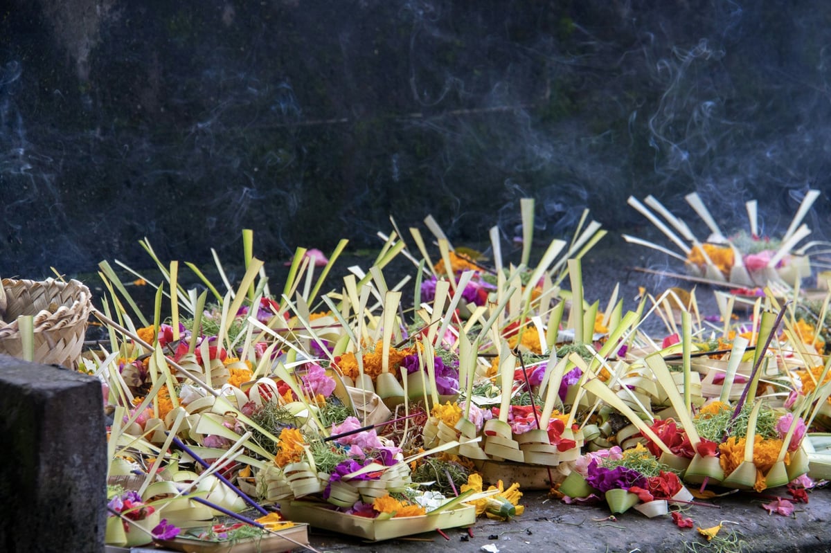 Flower and palm-leaf offerings laid out at a Balinese temple