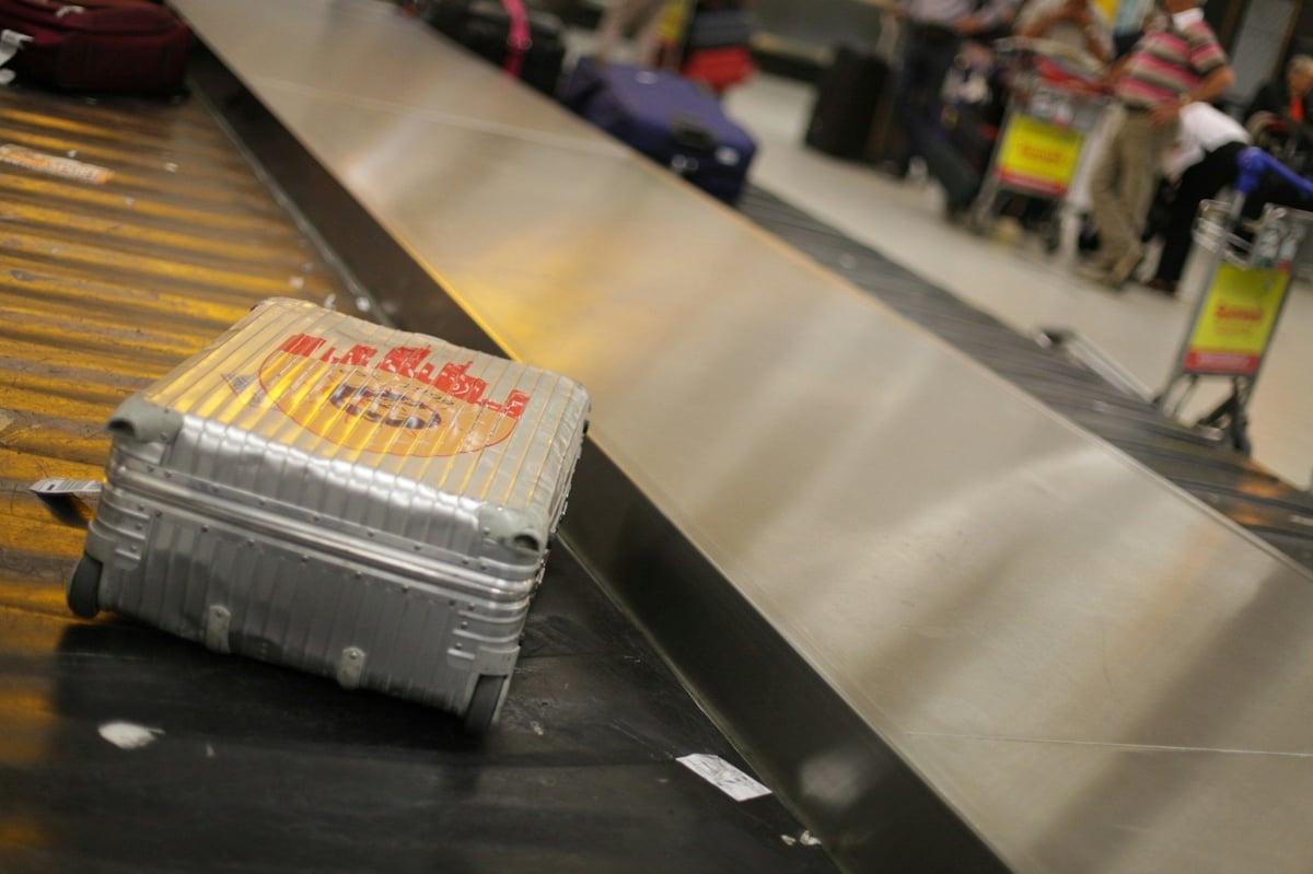A suitcase on an airport baggage belt