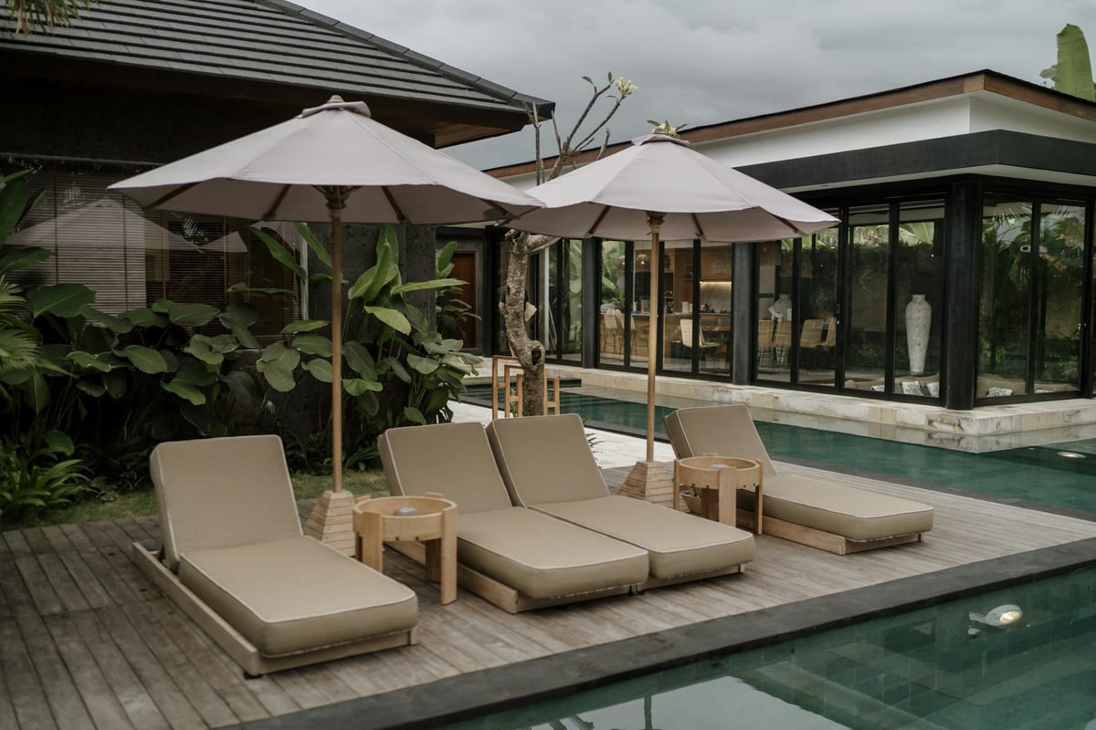 Sun loungers and umbrellas beside a hotel pool in Bali