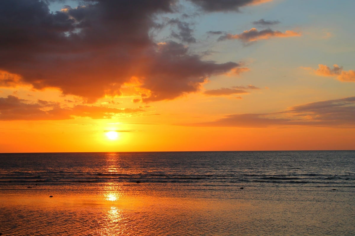 The sun low over the sea in Bali