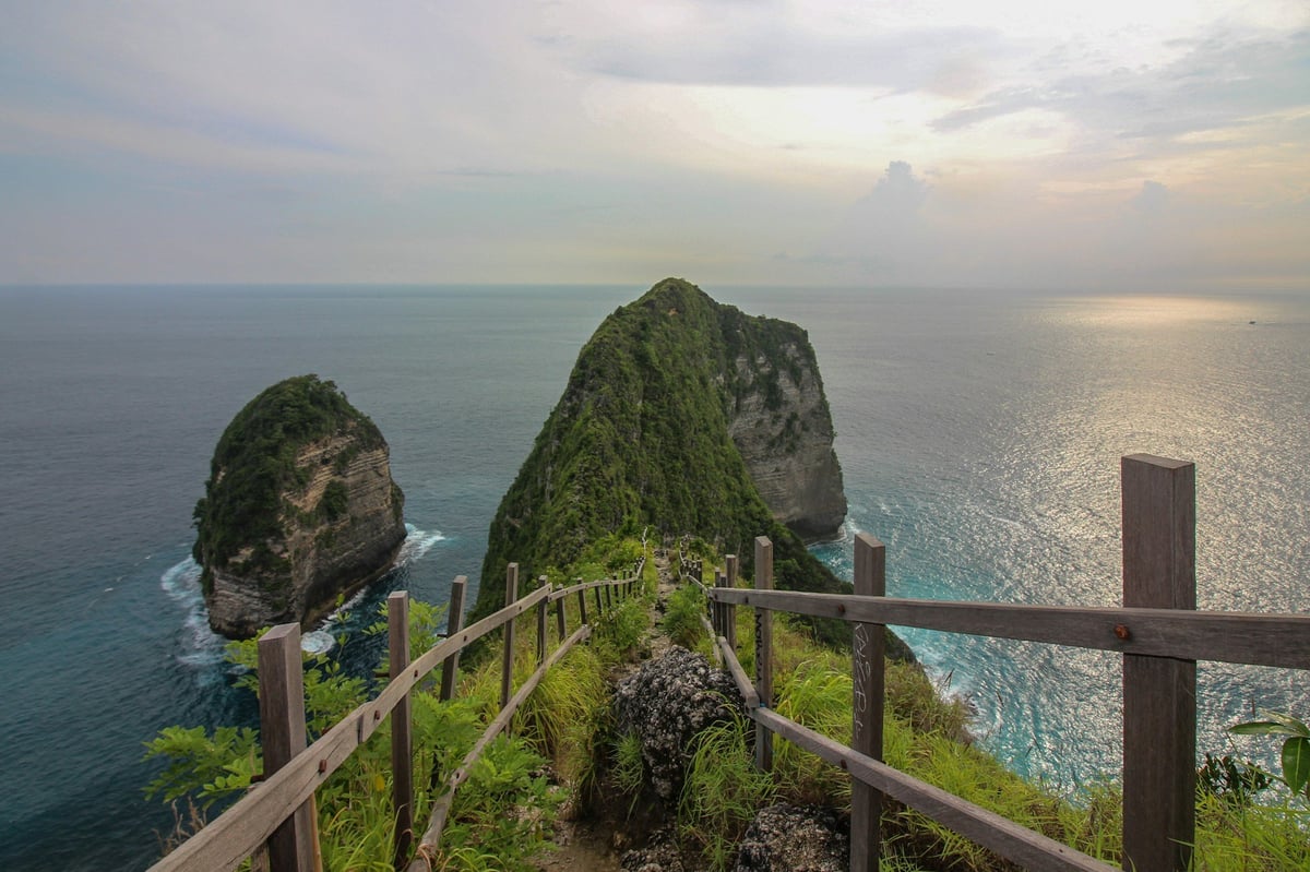 A fenced clifftop path above the sea on Nusa Penida