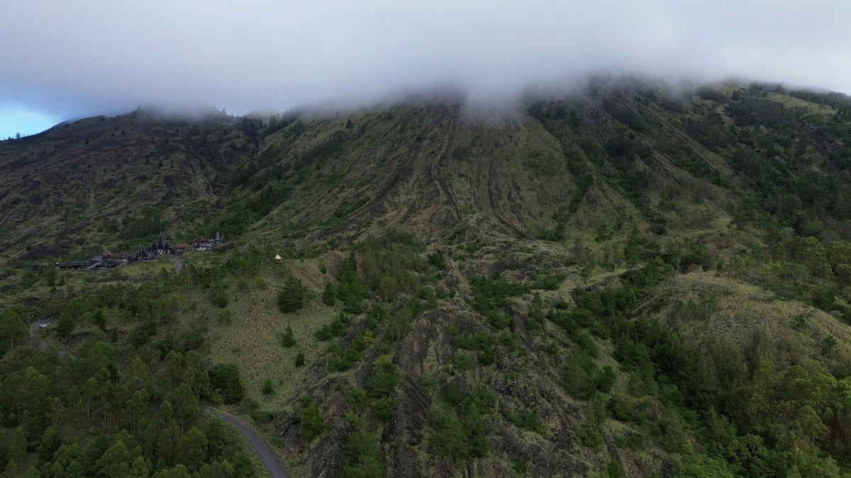 The green slopes of a volcano in Bali under low cloud