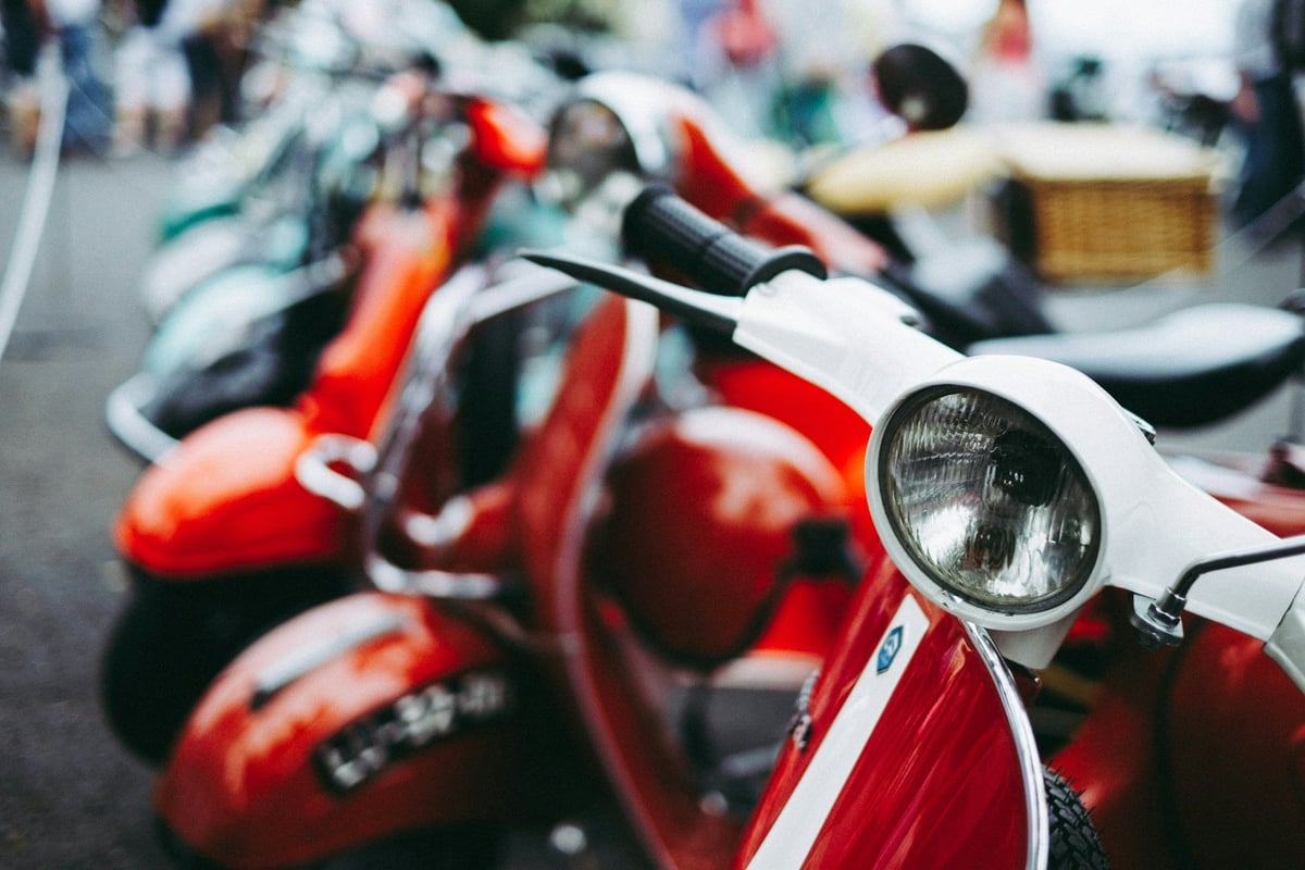 A row of parked scooters seen close up