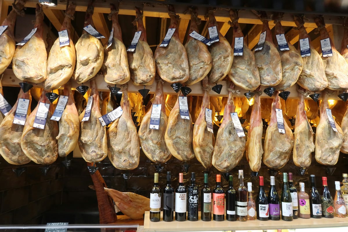 Jamón ibérico legs hanging in a Spanish shop