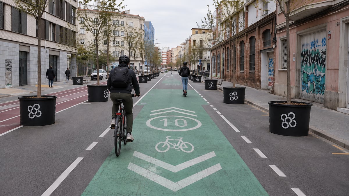 A cyclist and e-scooter rider sharing a dedicated bike lane in Barcelona