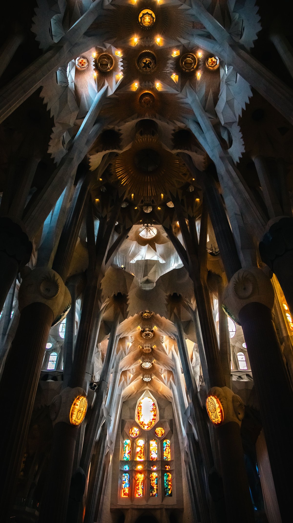 Interior nave with the tree-like columns and stained glass light, no people prominent