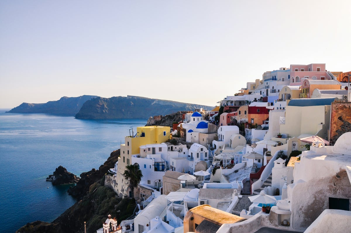 Classic Santorini caldera view, white buildings and blue domes above the sea