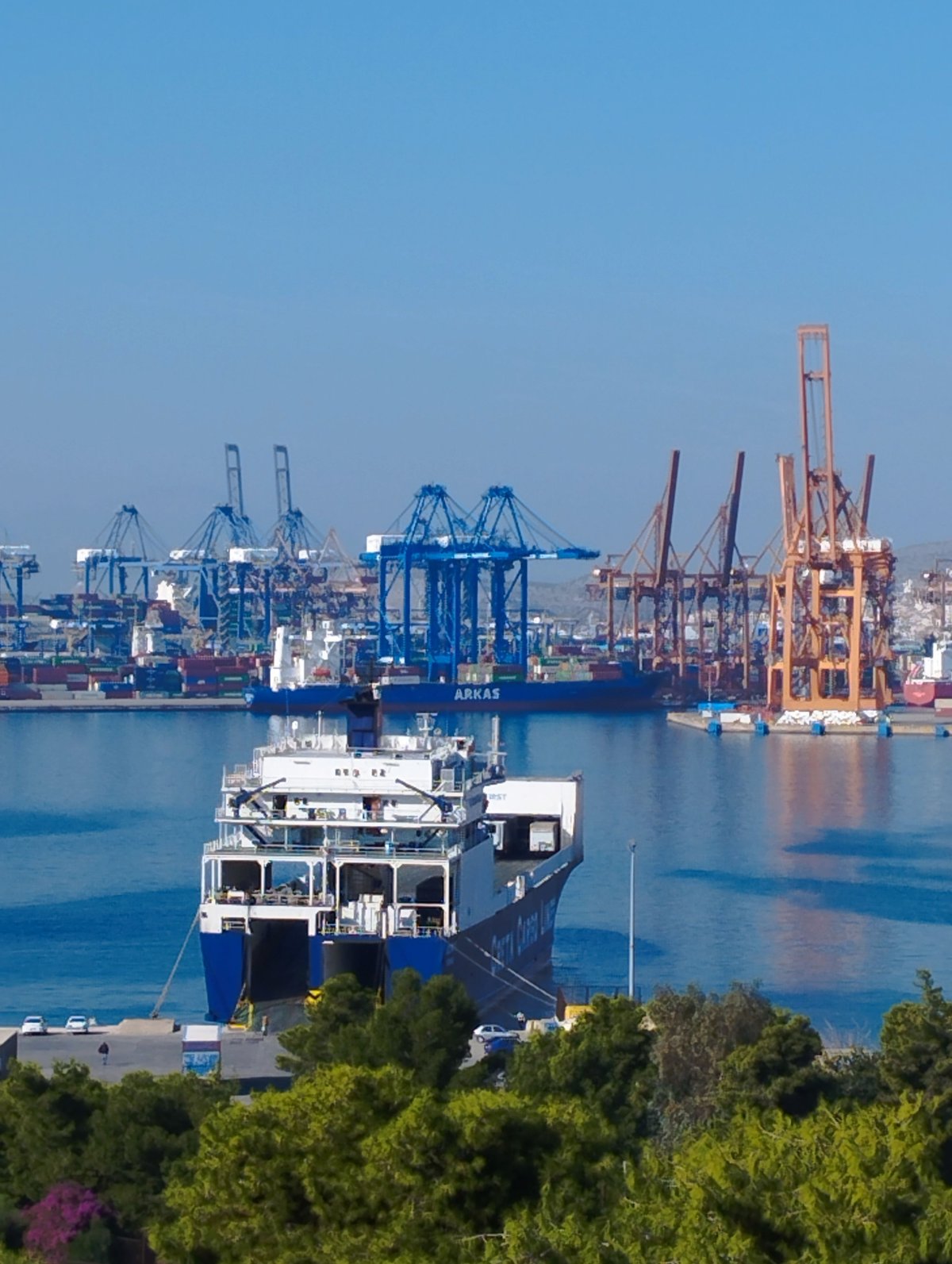 The busy port of Piraeus with ferries, or a transfer van at the airport