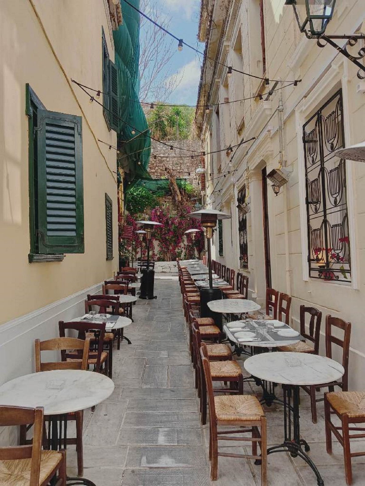 A charming Plaka lane with neoclassical houses and café tables