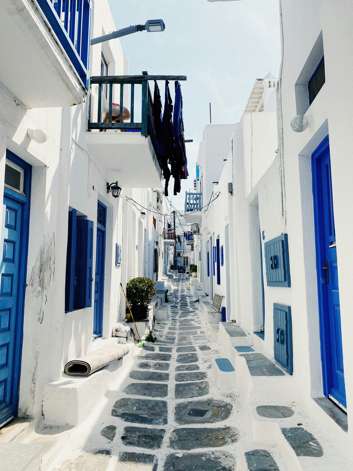 Whitewashed lanes of Mykonos Town with bougainvillea and blue doors