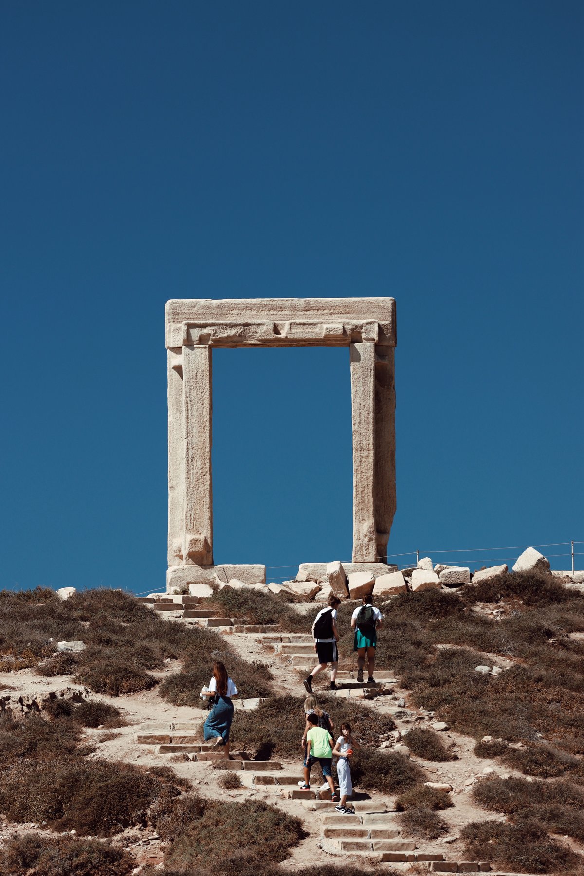The marble Portara gateway on Naxos with the sun setting through it