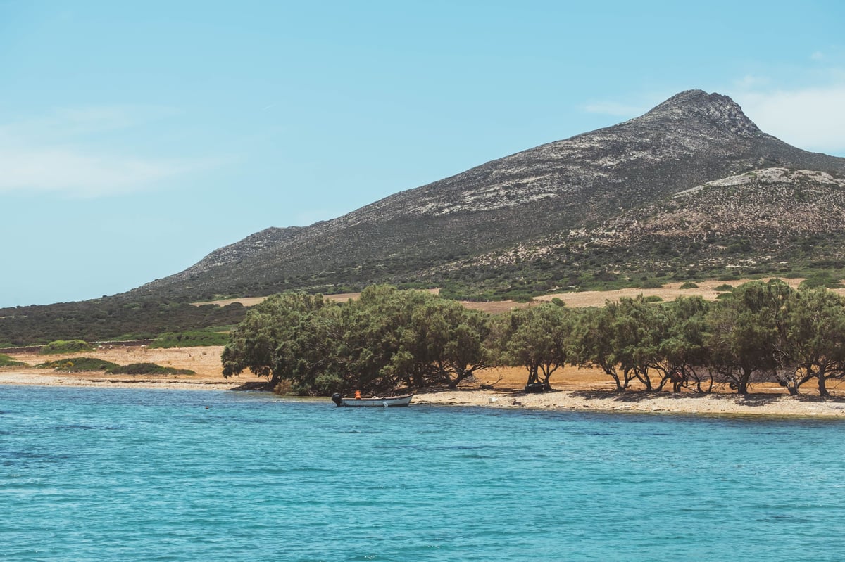 A Cycladic island vista — whitewashed village above blue Aegean water