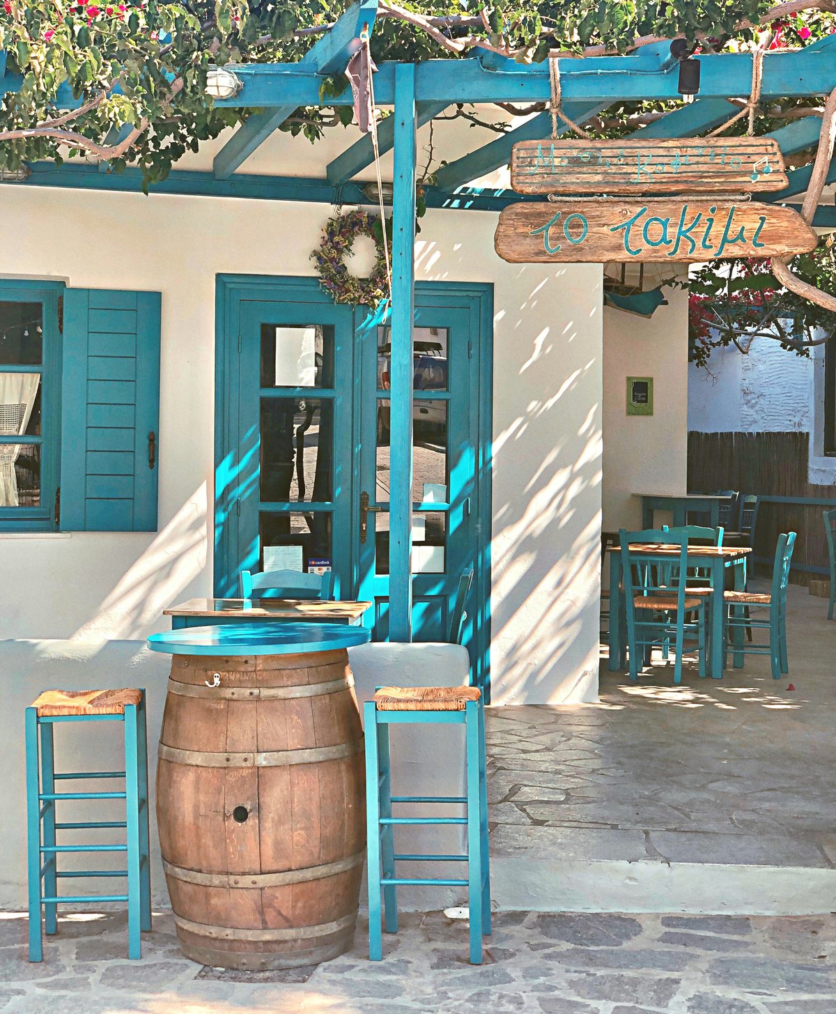 A relaxed Greek scene suggesting good value — a taverna or village street
