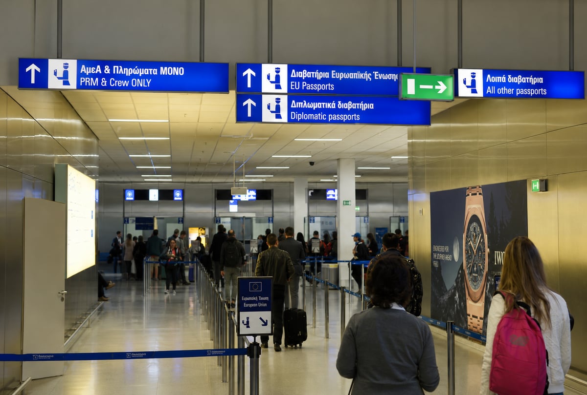 A modern airport border control / e-gates area (no identifiable faces)