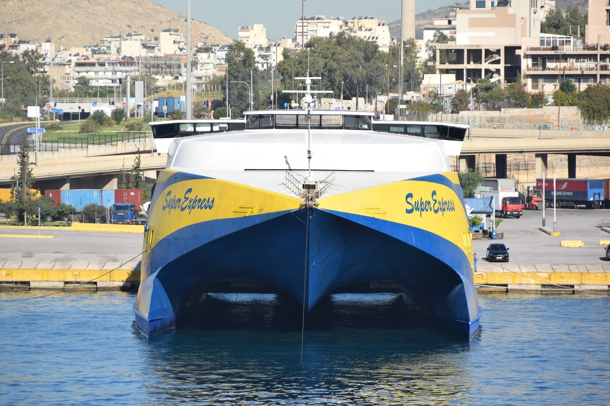 A large conventional Greek ferry and a sleek high-speed catamaran