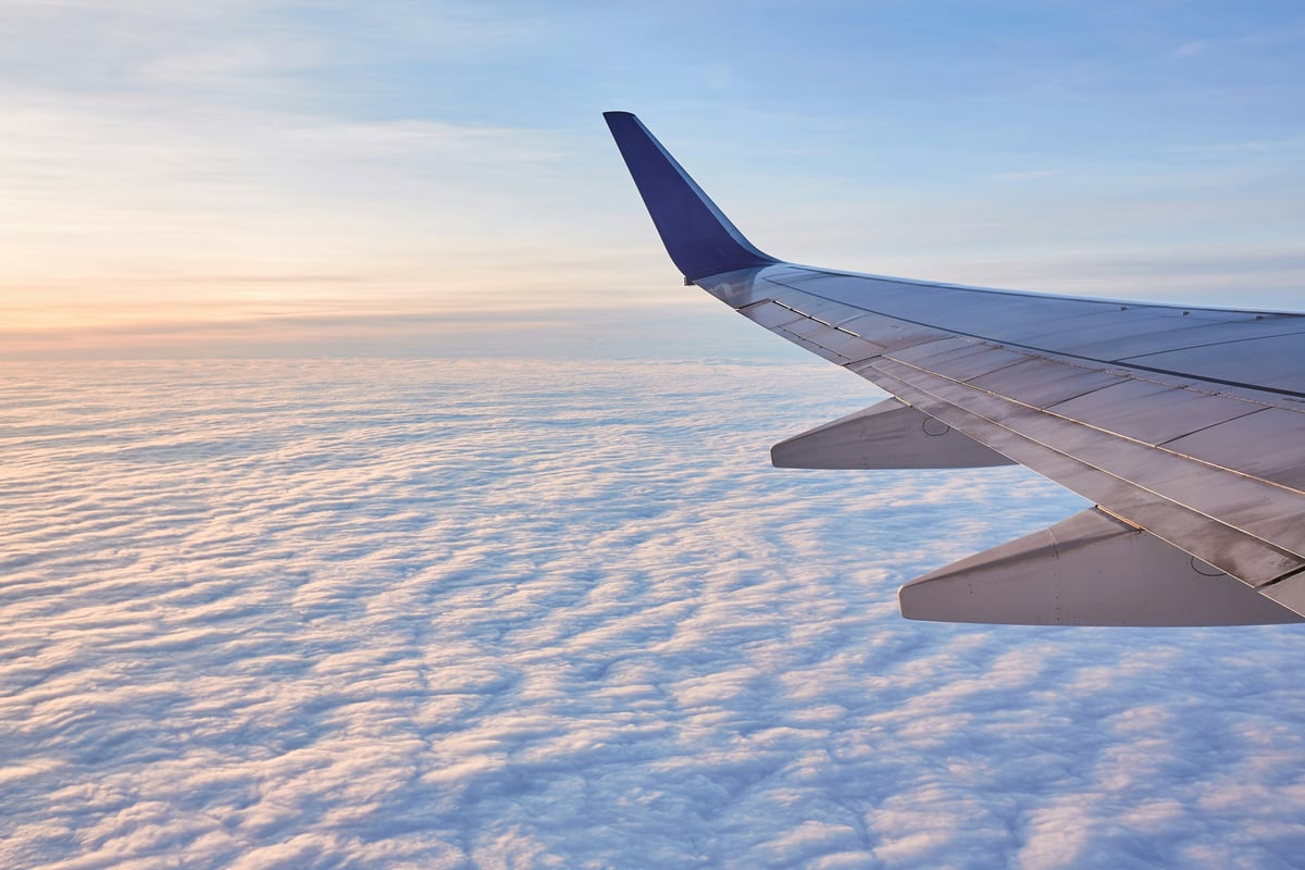A wide-body airliner in flight or at a gate, evoking transatlantic travel