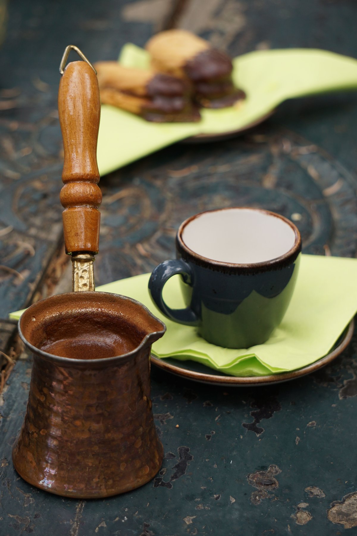 A traditional Greek coffee served in a small cup with a glass of water