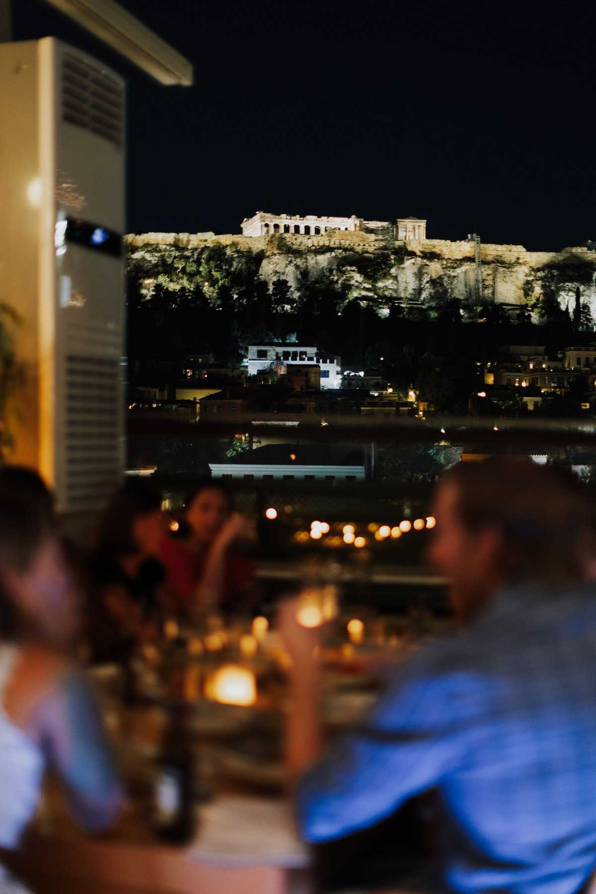 A relaxed Greek social scene — people lingering at a taverna or café