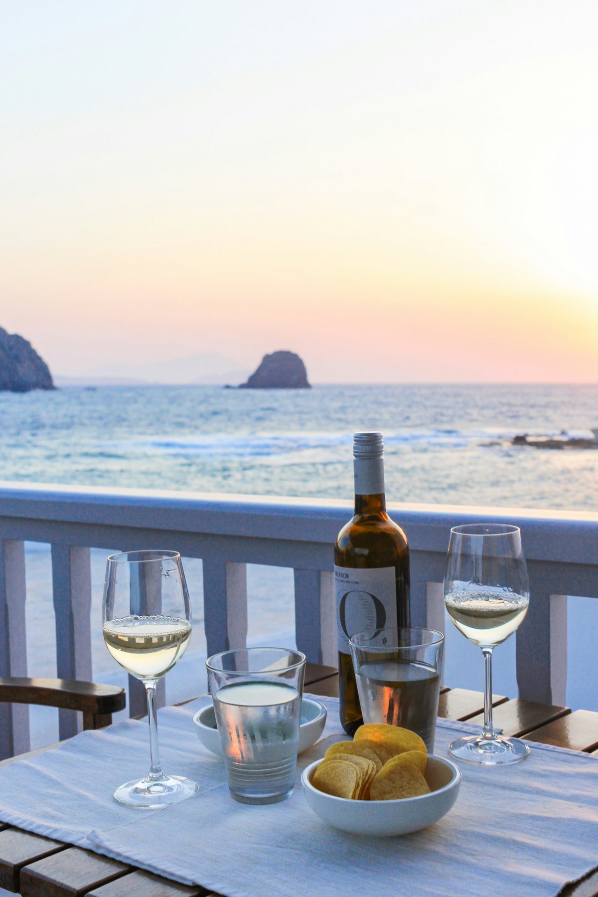 A Santorini winery terrace with vines and a caldera view
