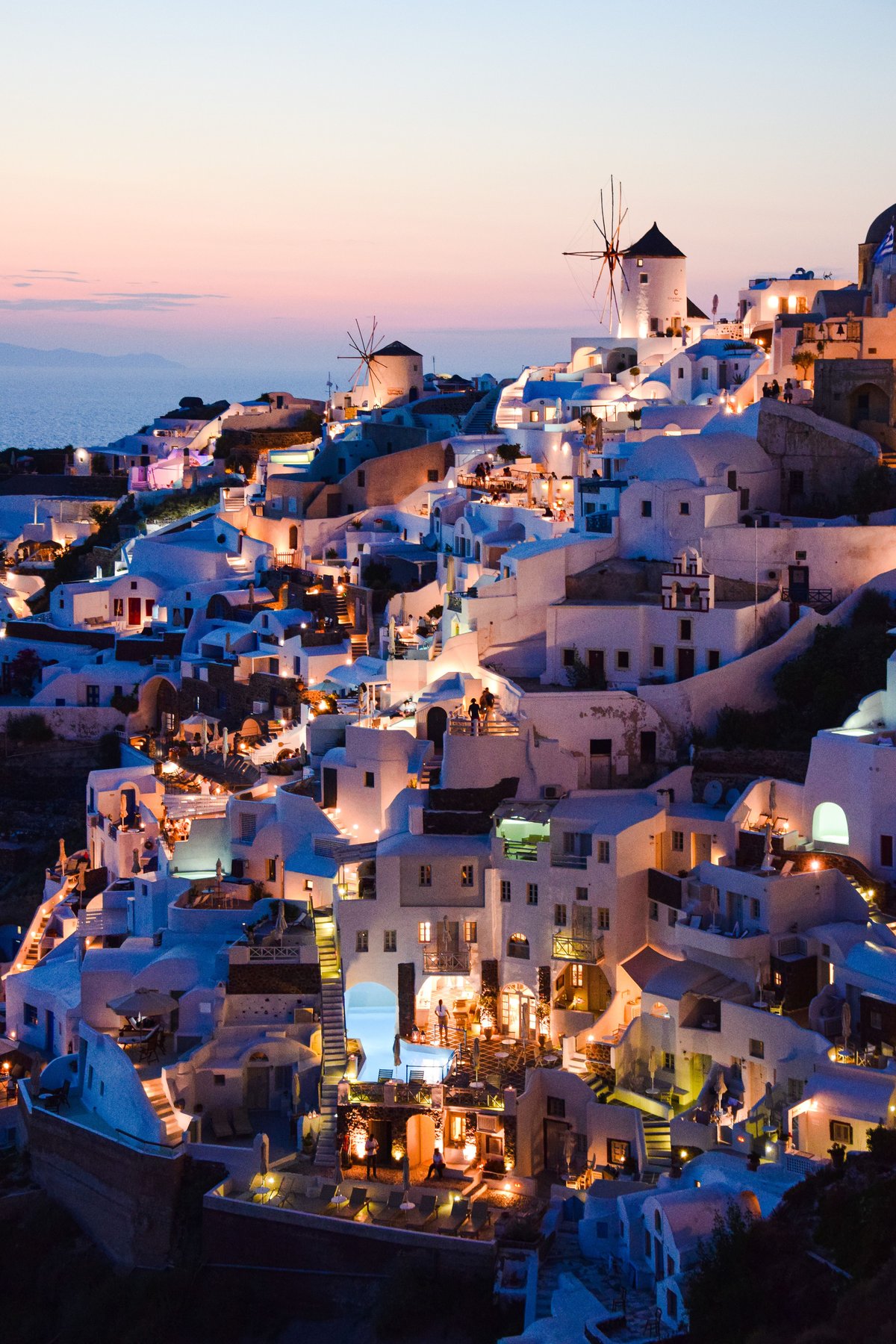 A relaxed, safe-feeling Greek street scene or harbor in the evening