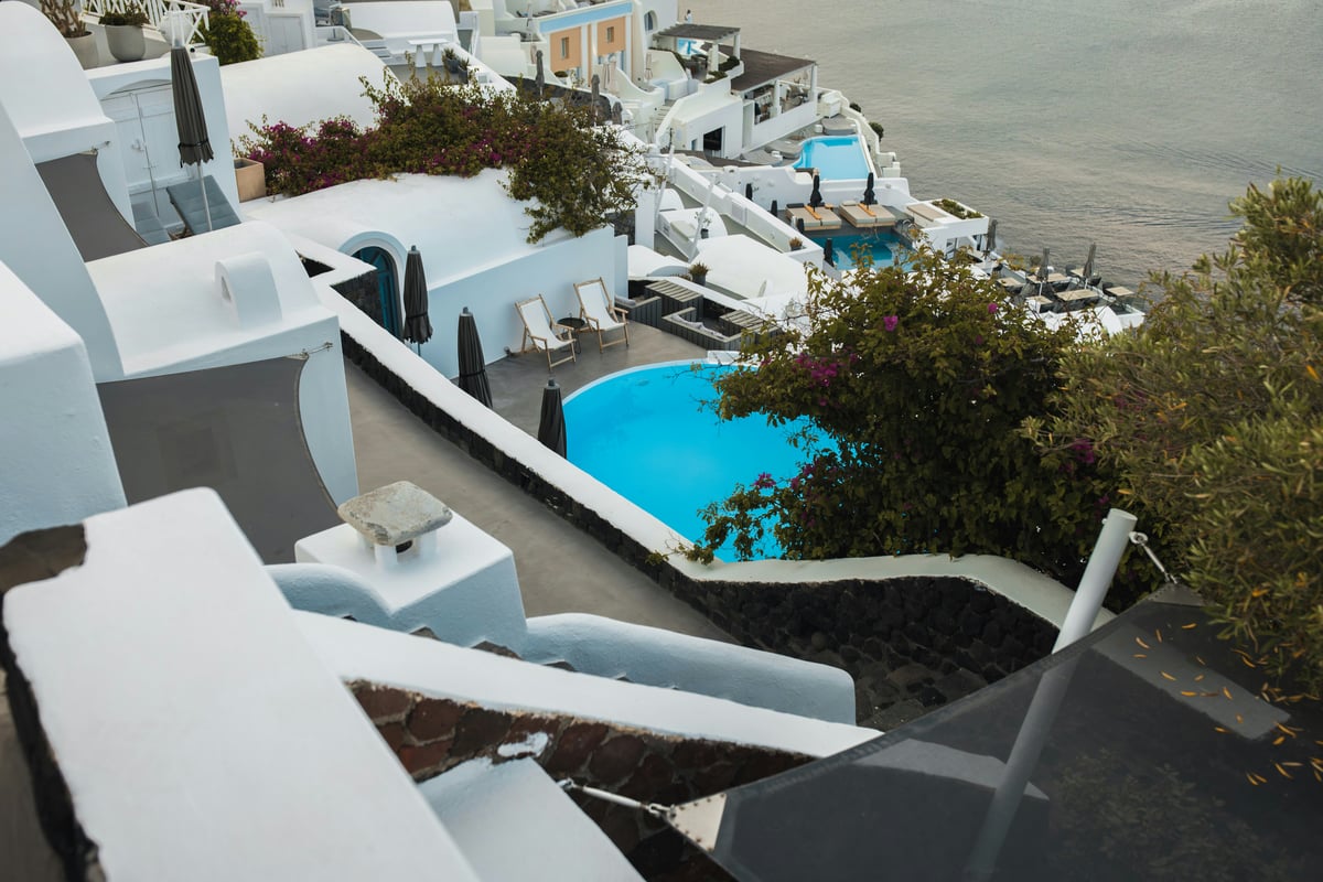 An elegant seaside fine-dining table or a luxury resort pool overlooking the Aegean