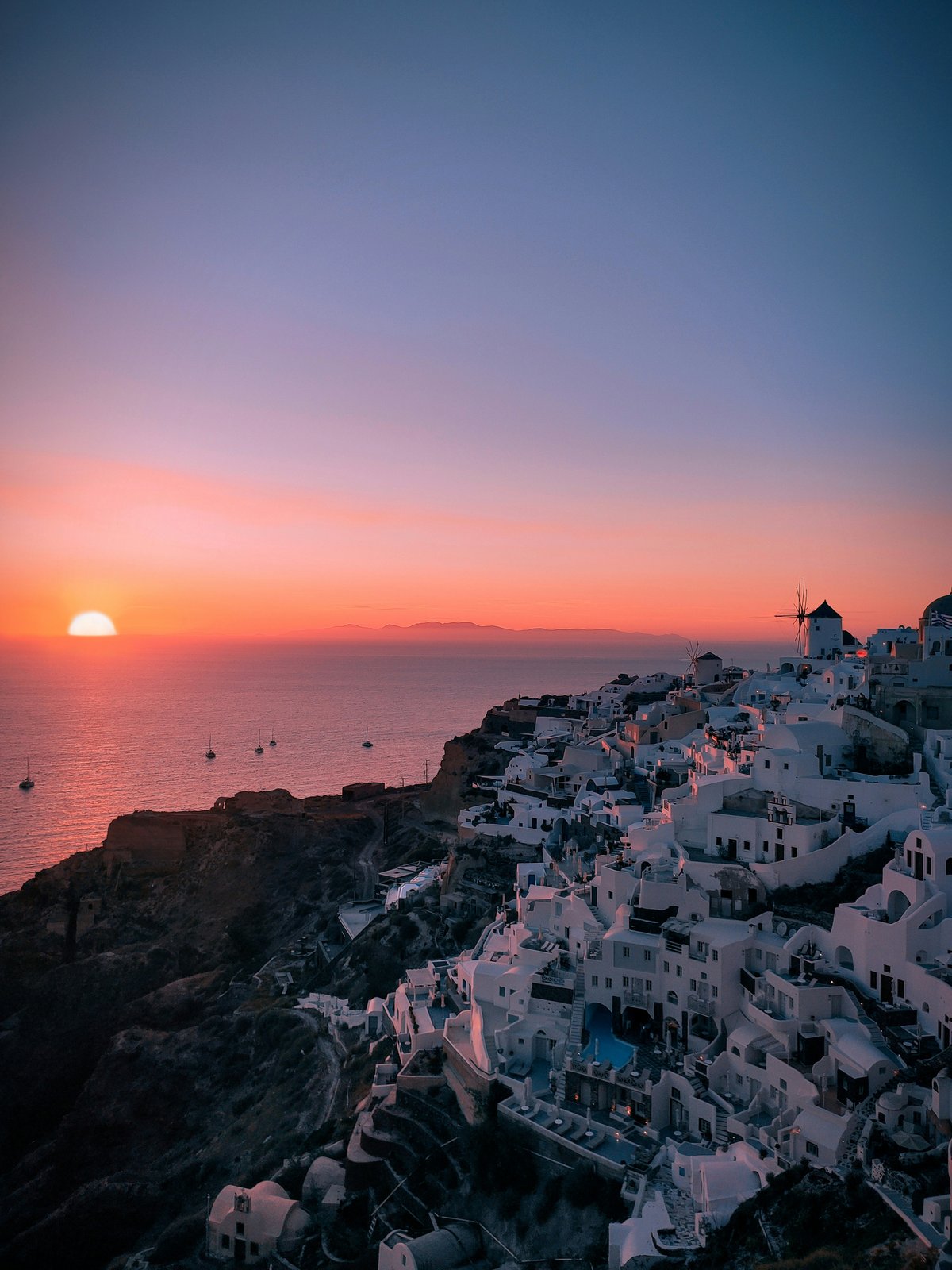 A couple's-eye view of the Santorini caldera at sunset from a private terrace