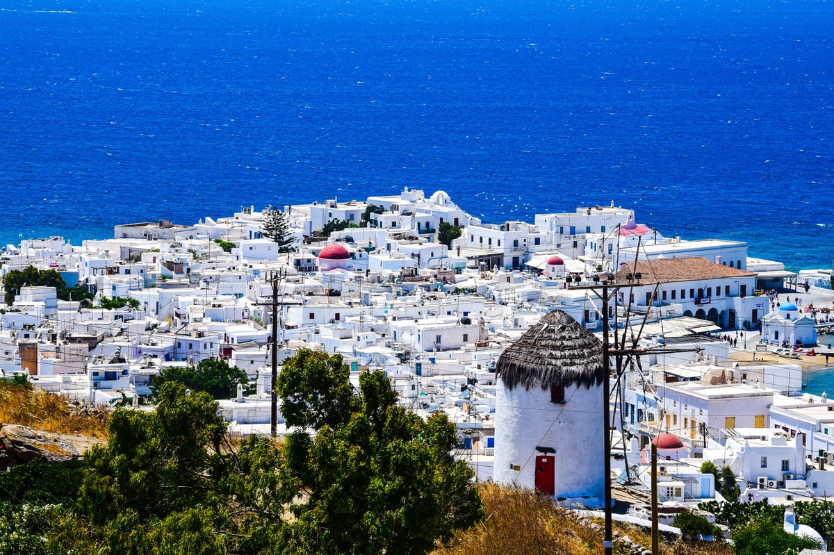 Mykonos Town windmills and whitewashed Chora at golden hour