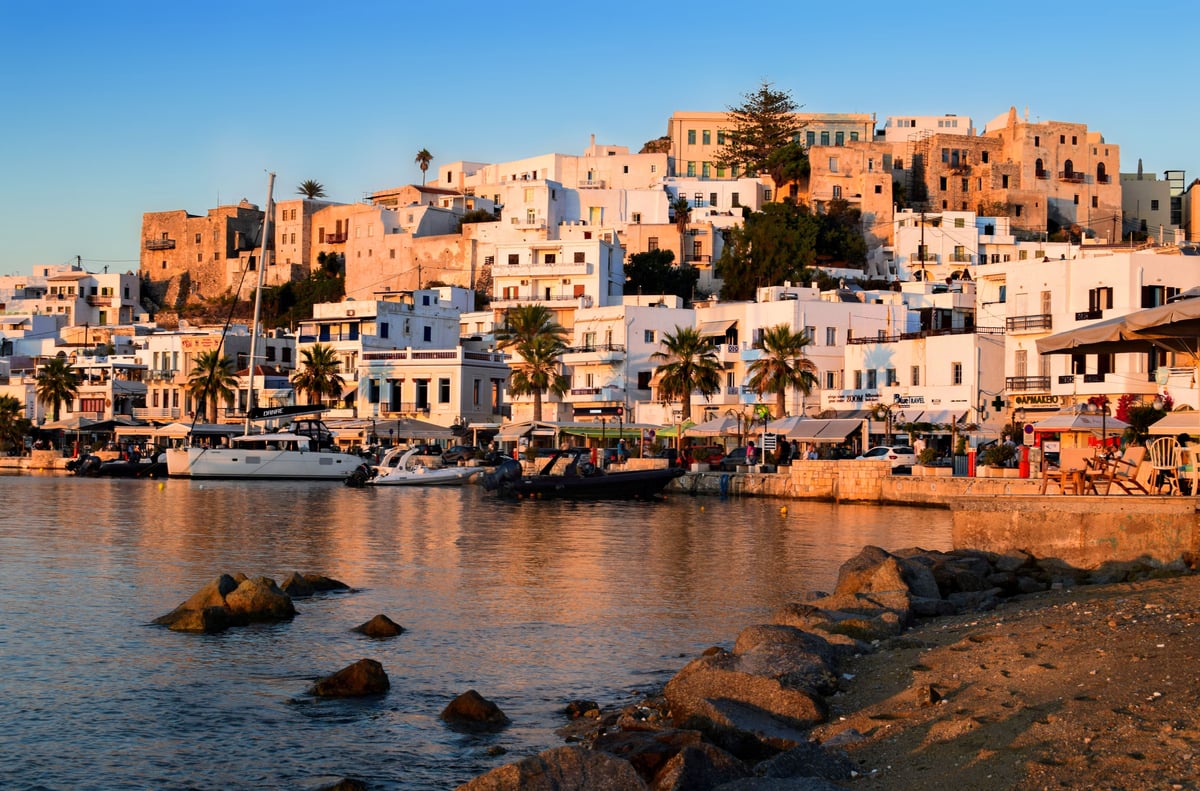 Naxos Chora with the marble Portara gateway at sunset, harbor in view