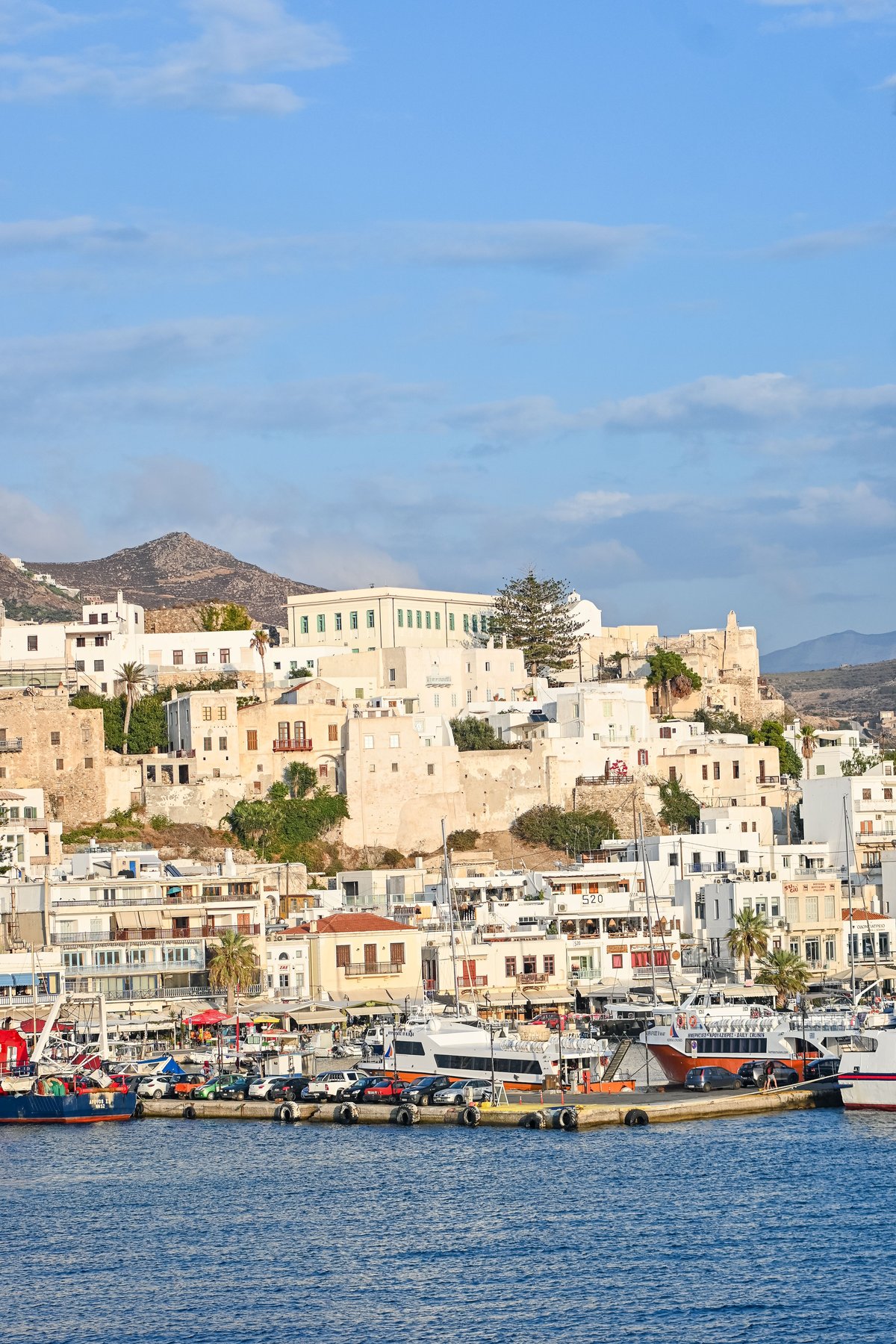 Split image — Naxos Portara/mountains vs Naoussa harbor on Paros