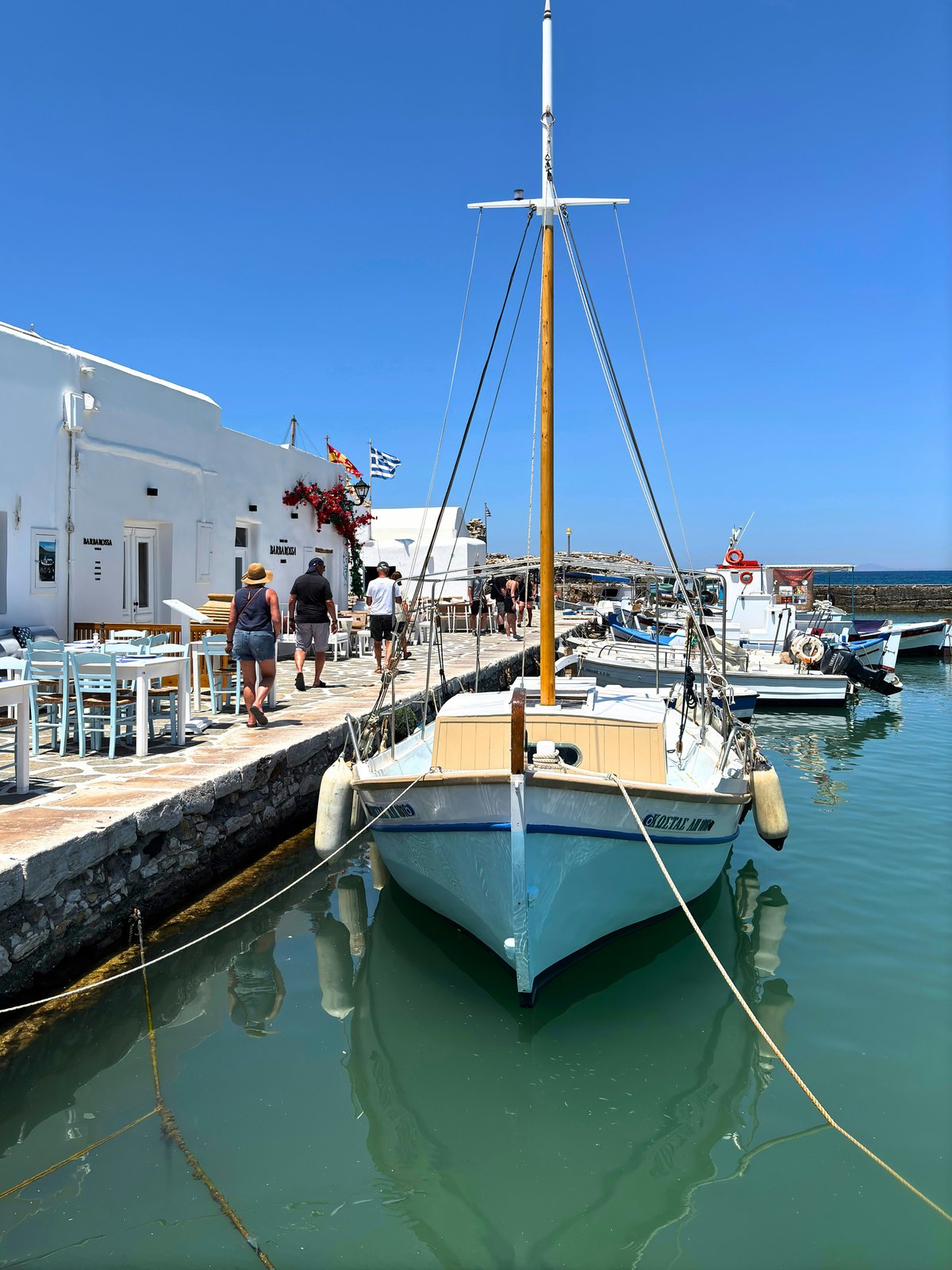Naoussa harbor on Paros at dusk, fishing boats and waterfront tavernas