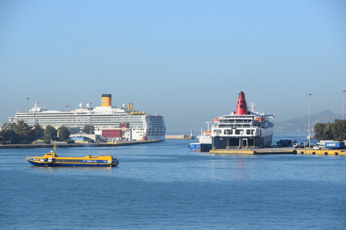 A wide view of the busy Piraeus harbor with multiple ferries docked