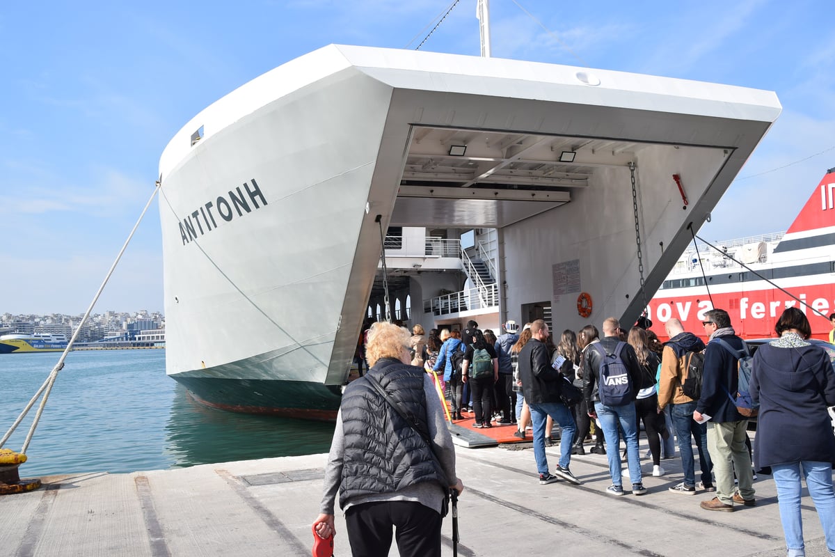 A large ferry boarding ramp at Piraeus with passengers walking aboard