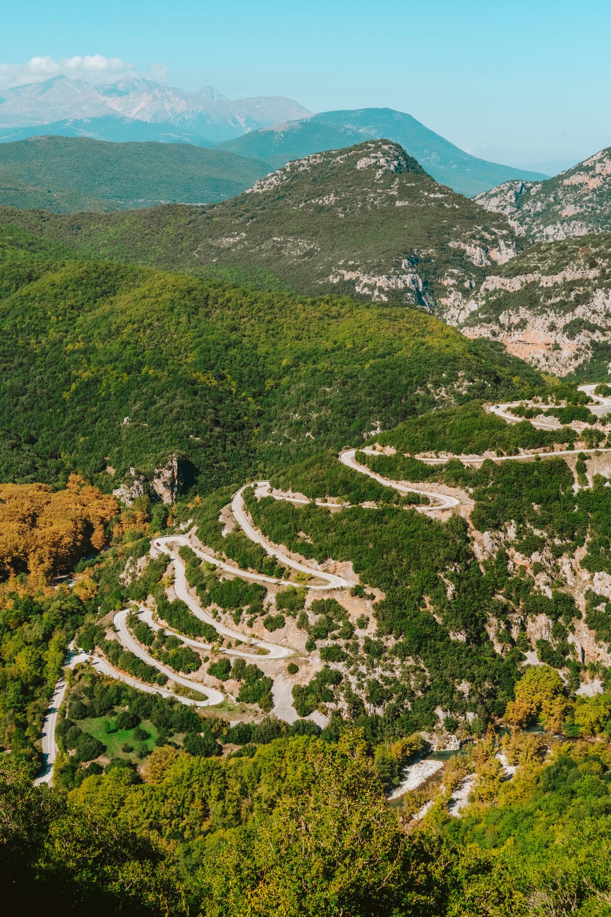 A scenic Greek coastal or mountain road winding through the landscape