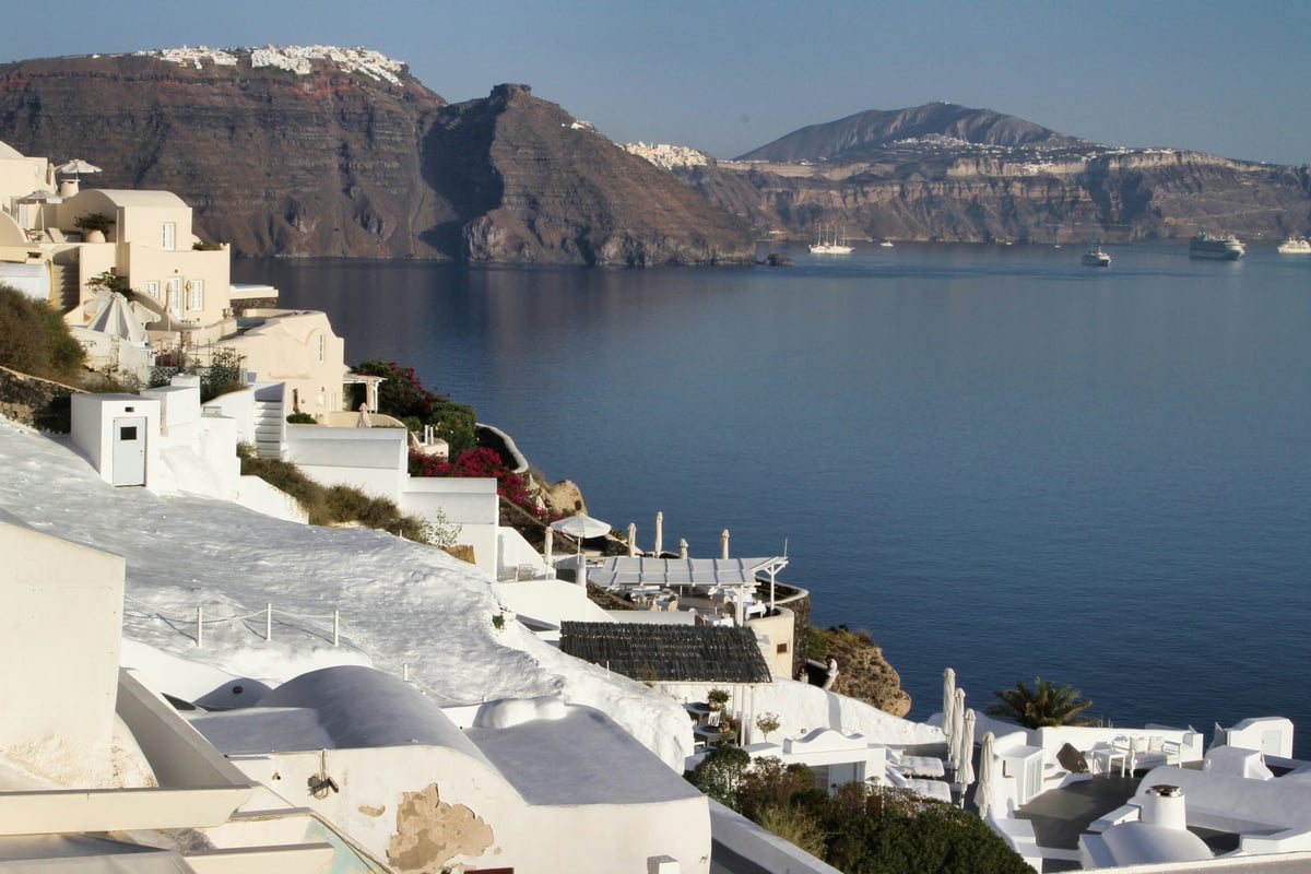 The village of Oia with its blue domes and caldera view, daytime
