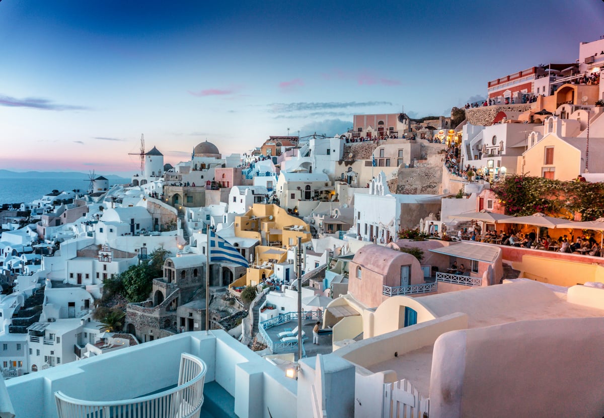 Split image — Santorini caldera on one side, Mykonos windmills/beach on the other