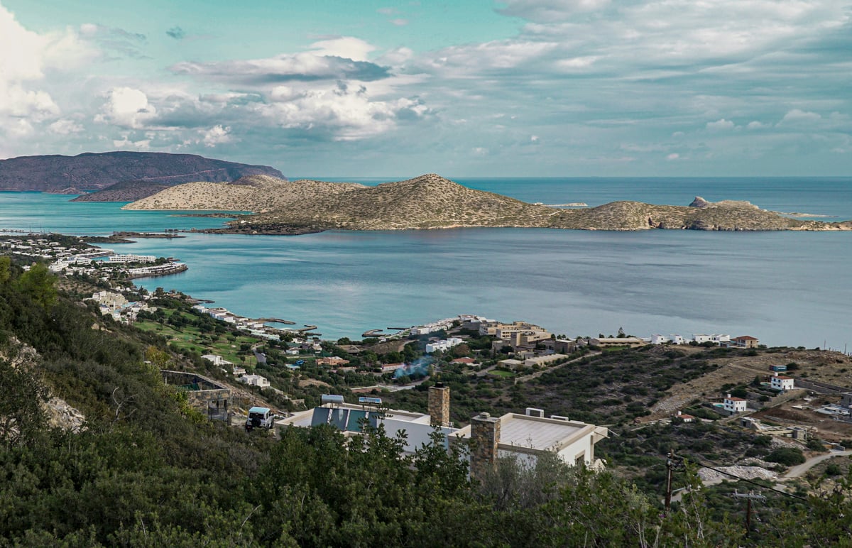 Split image — Chania's harbour in the west vs Elounda/Spinalonga in the east