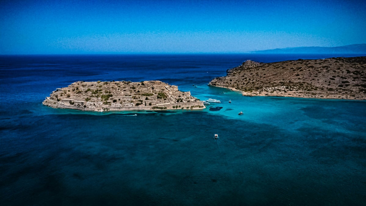 The fortress island of Spinalonga or a calm eastern Crete gulf view