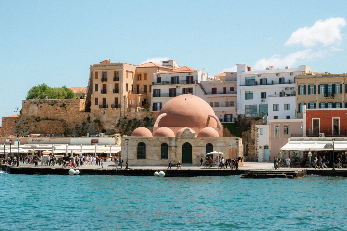 Chania's Venetian harbour at golden hour, old lighthouse and waterfront