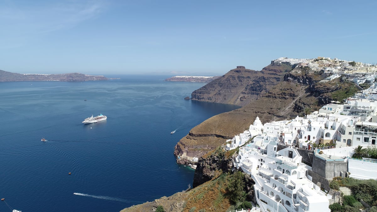 A split or contrast of a famous island vs a relaxed one (e.g. Santorini caldera vs Naxos beach)