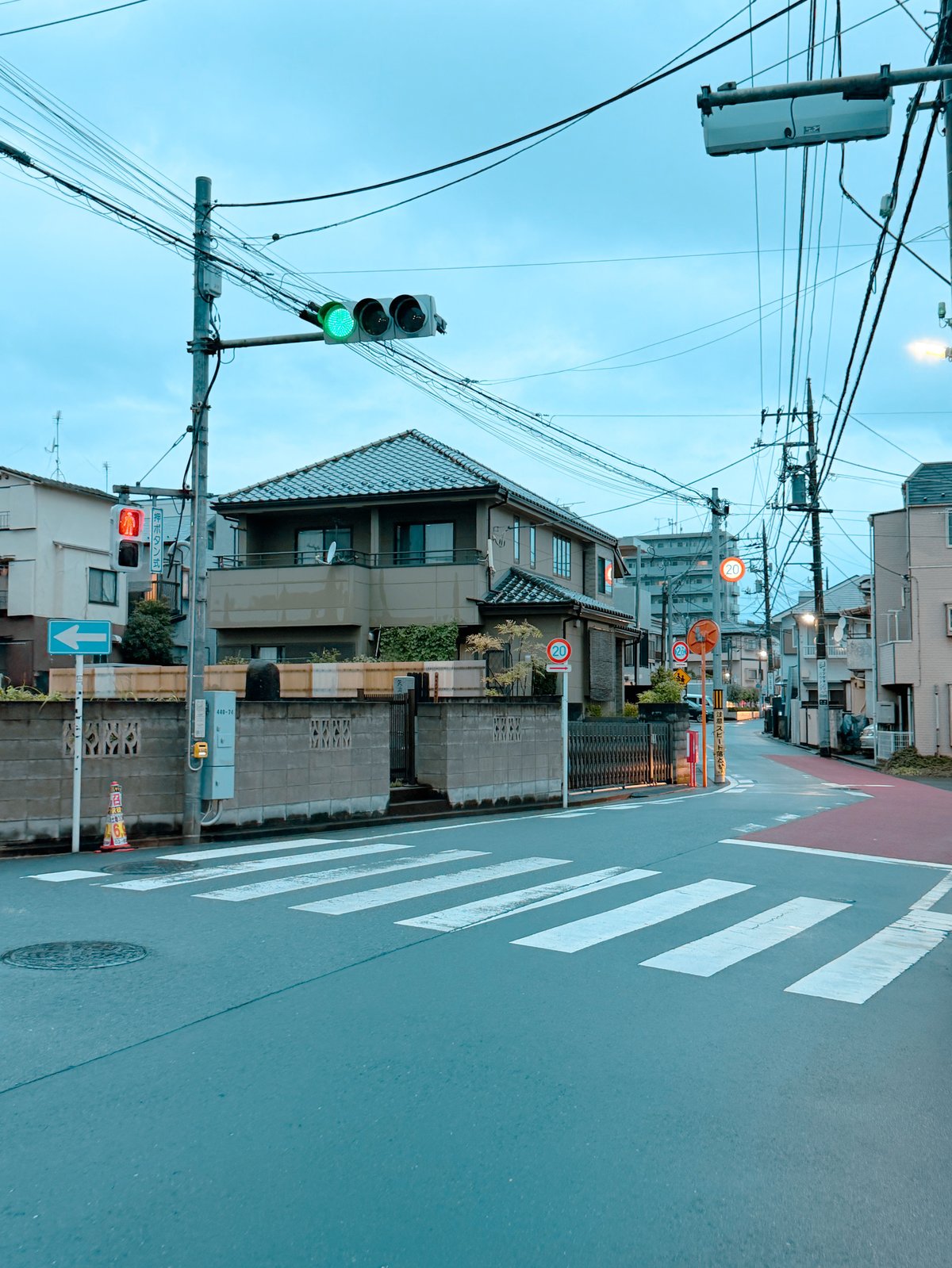 A quiet residential Tokyo intersection at dusk