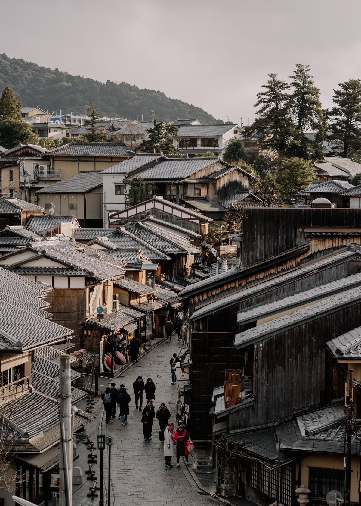 The sloped street of Sannenzaka lined with traditional wooden buildings in Kyoto's Higashiyama district