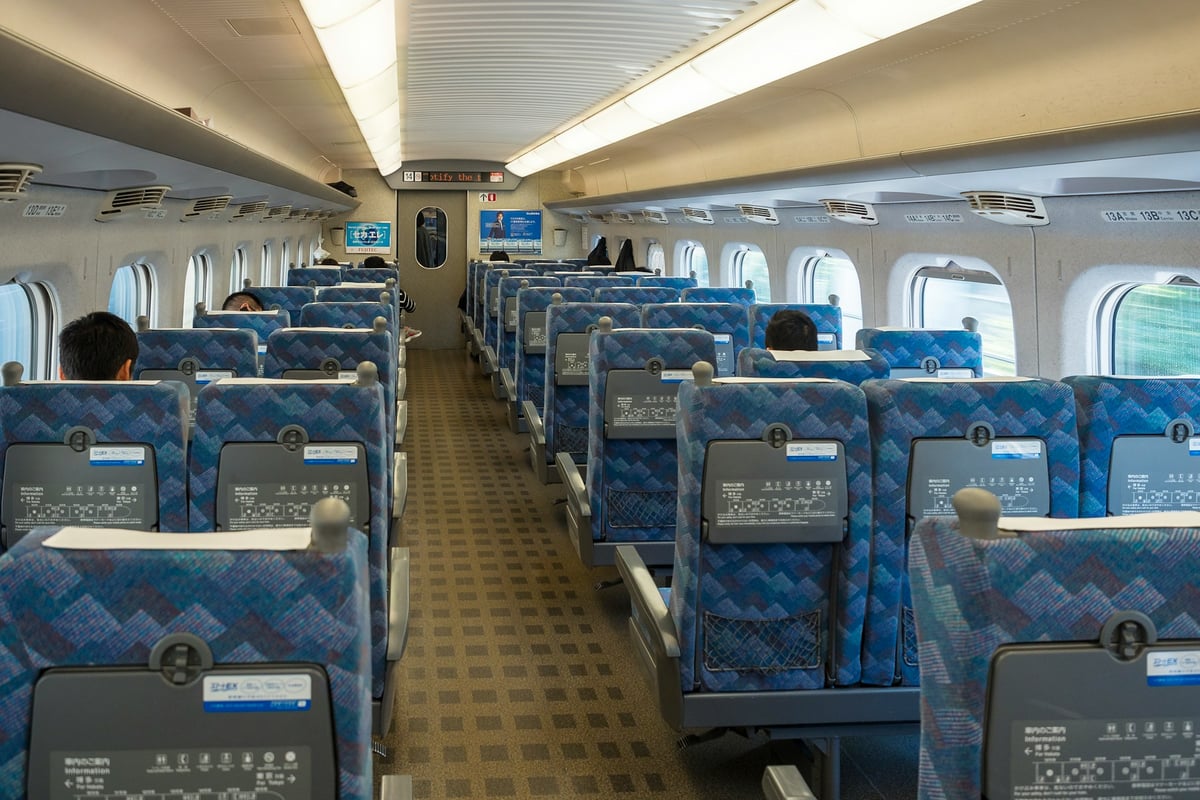 Interior of a Shinkansen ordinary car, blue seats in the standard two-and-three layout