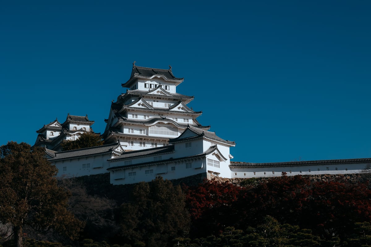 Himeji Castle's white multi-tiered keep against a blue sky