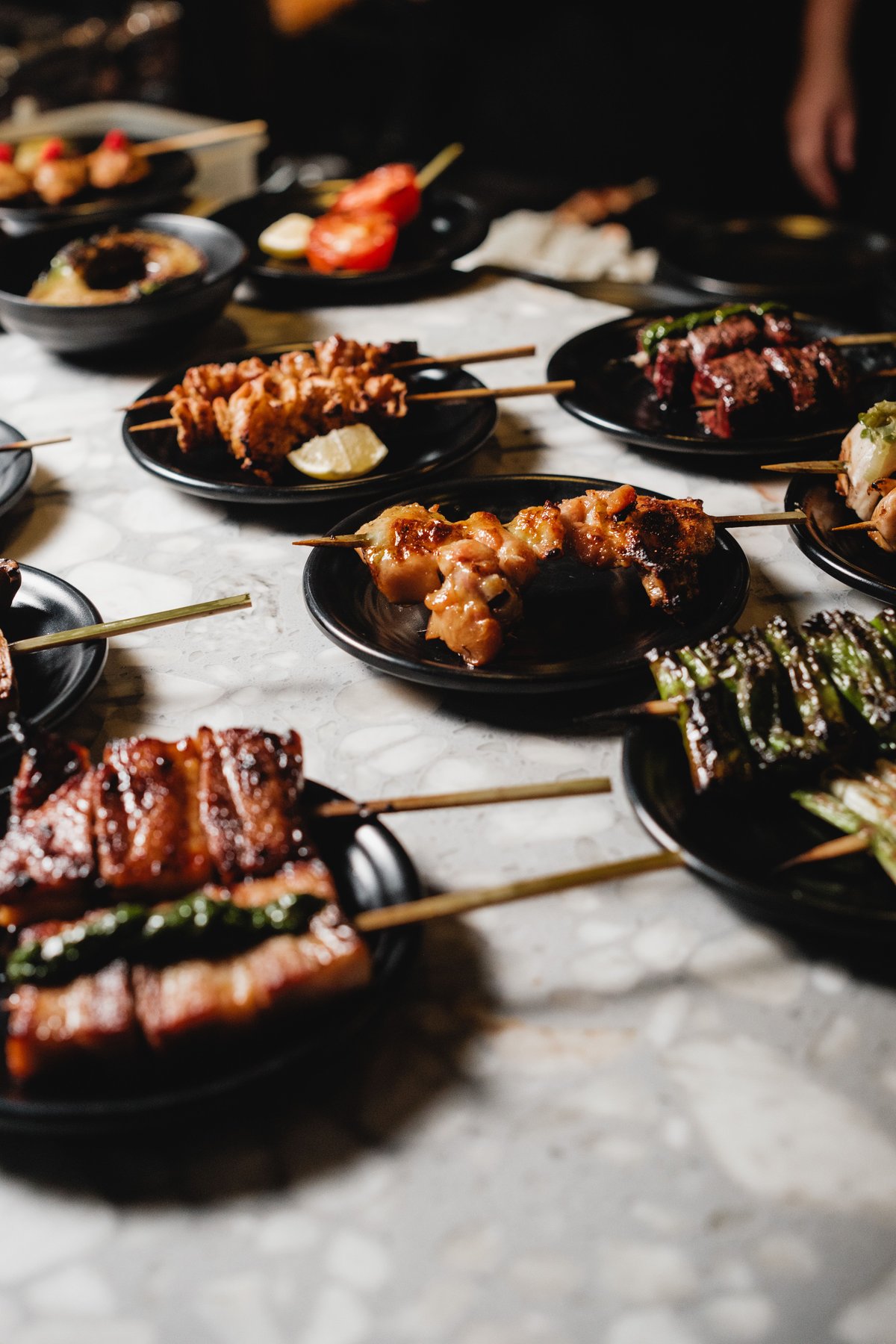 An assortment of grilled yakitori skewers served on plates